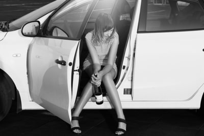 Arresto por DUI - Chica con botella de vino sola en carro